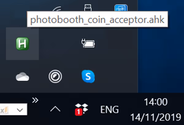 Windows system tray icon showing Breeze photobooth_coin_acceptor.ahk script is running